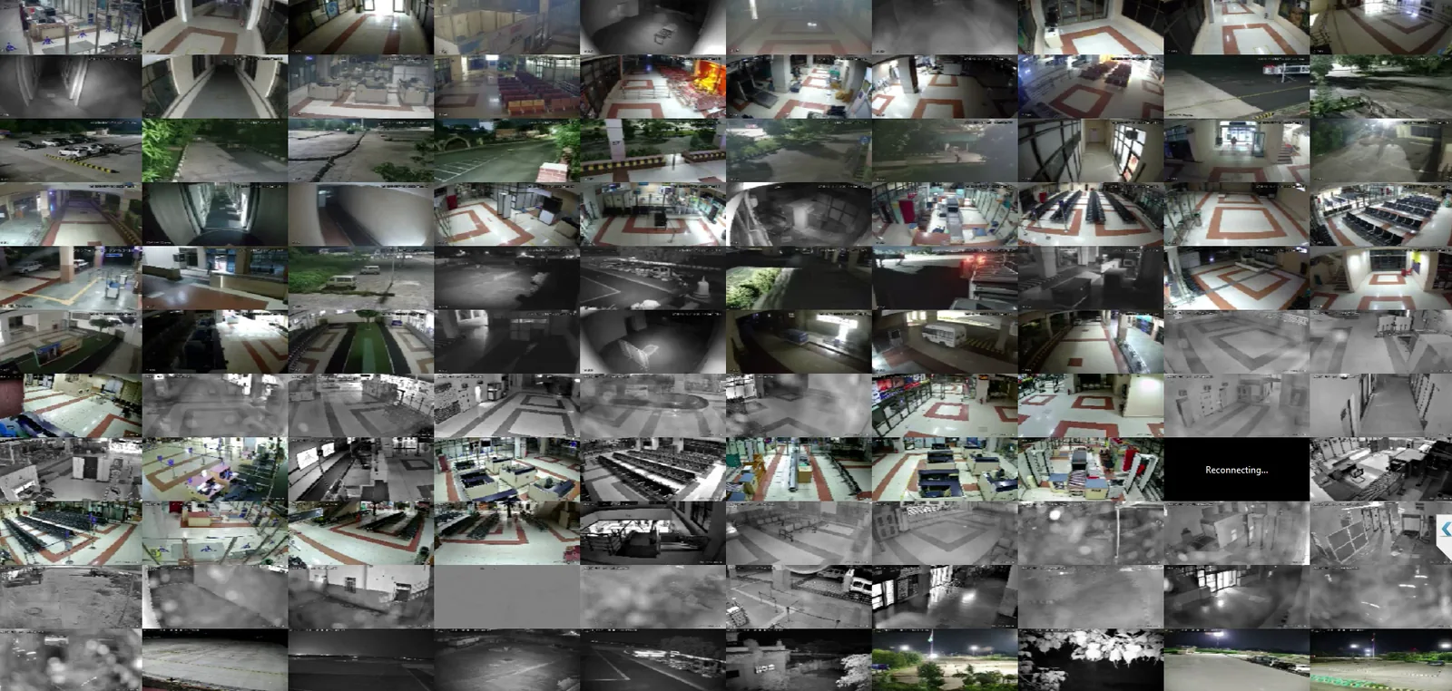 A dense grid of small camera views showing halls, corridors, seating areas and car parks, many in black-and-white night mode. One view reads 'Reconnecting...'.